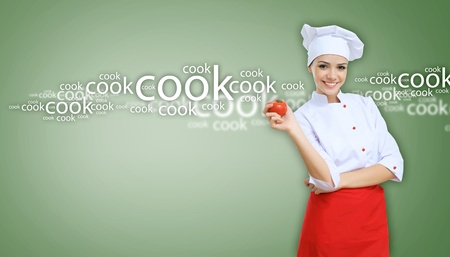 Young female chef in red apron against collour backgroundの写真素材