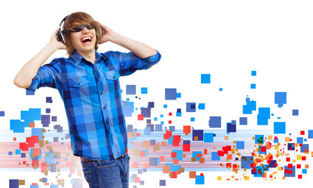 Happy smiling young man dancing and listening to music