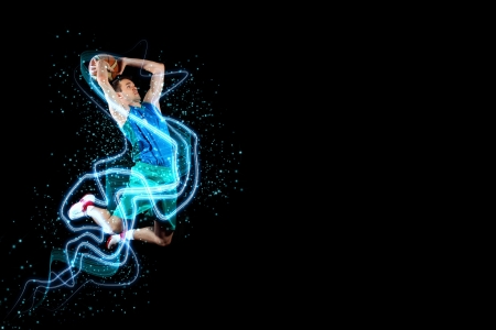 Male basketball player jumping and practicing with a ballの写真素材