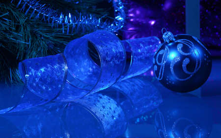 Blue Christmas collage  Ball and ribbon on a blue background の写真素材