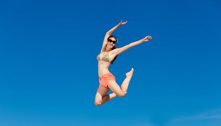 Fashion shot of beautiful woman on the beachの写真素材