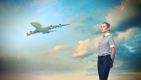 Busines person and plane on the background against cloudy skyの写真素材