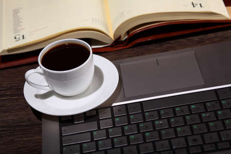 White cup with black coffee at business workplaceの写真素材