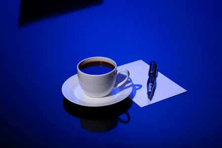 White cup with black coffee at business workplaceの写真素材
