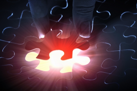 puzzle piece coming down into its placeの写真素材