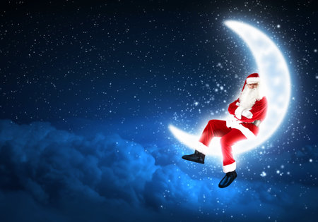 a Santa Claus sitting on shiny moon above winter forestの写真素材