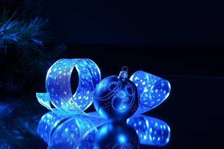 Blue Christmas collage  Ball and ribbon on a blue background 