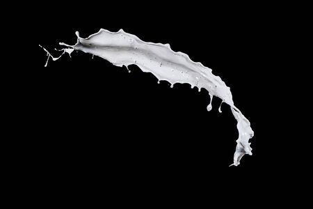 White milk splash isolated on black backgroundの写真素材