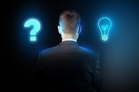 Senior businessman thinking and making choice while looking upの写真素材