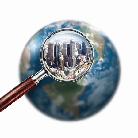 Conceptual mini planet with skyscrapers on it under a magnifying glass  Elements of this image are furnished by NASAの写真素材