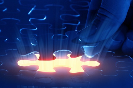 puzzle piece coming down into its placeの写真素材