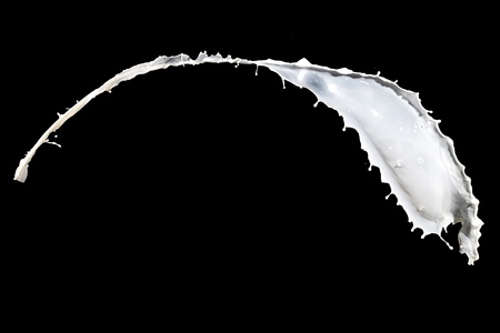 White milk splash isolated on black backgroundの写真素材