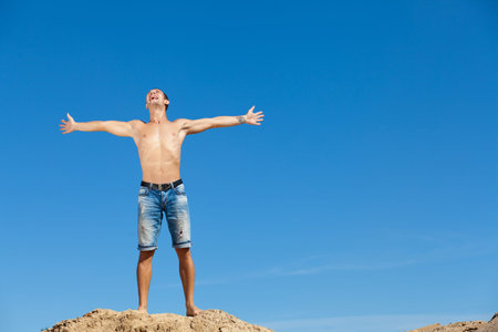 Portrait of a happy young man having fun on the beach on a summer vacation の写真素材