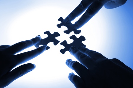 puzzle piece coming down into its placeの写真素材