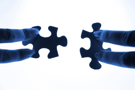 puzzle piece coming down into its placeの写真素材