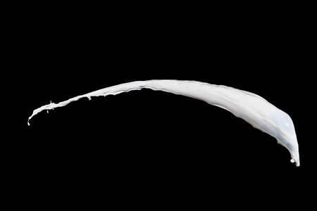 White milk splash isolated on black backgroundの写真素材