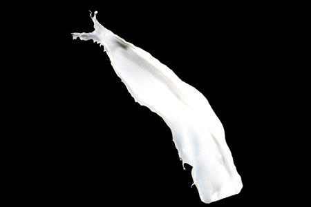 White milk splash isolated on black backgroundの写真素材