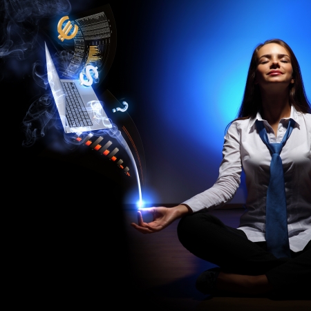 Businesswoman with financial symbols around her on the backgroundの写真素材