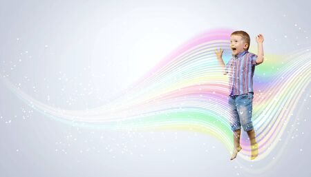 Photo of little boy jumping and raising handsの写真素材