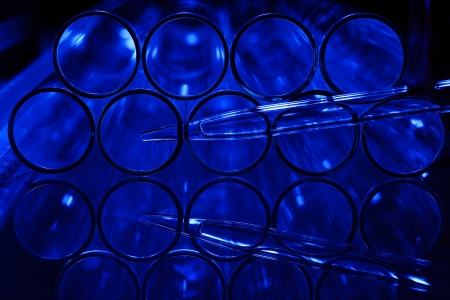 Glass chemistry tubes on a colour backgroundの写真素材