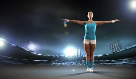 Image of sportswoman exercising against stadium lights backgroundの写真素材