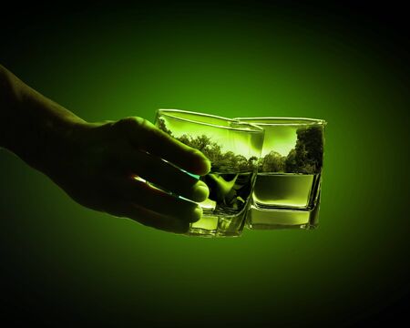 Two glasses of green absinth with nature illustration inの写真素材