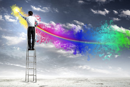 young man standing with back on ladder painting splashes