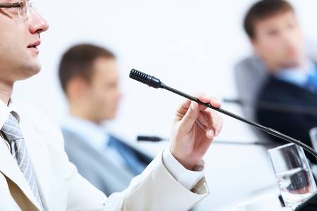 Image of three businesspeople at table at conferenceの写真素材