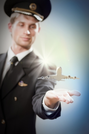 Image of pilot with airplane taking off from his handの写真素材