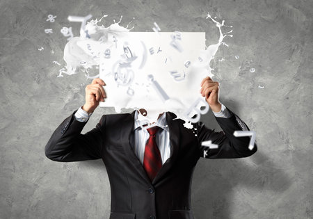 Image of businessman holding message board  Conceptual photoの写真素材