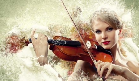 Image of beautiful female violinist playing with against colorful backgroundの写真素材