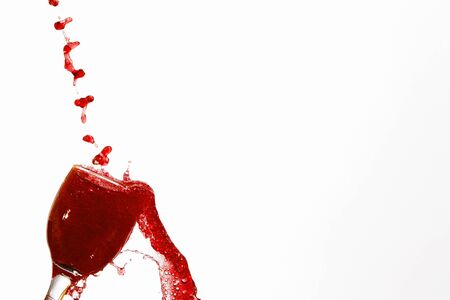 Red Juice splash and glass isolated on whiteの写真素材