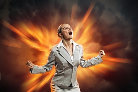 businesswoman in anger screaming standing in flash of lightの写真素材