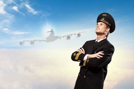 Image of male pilot with airplane at backgroundの写真素材