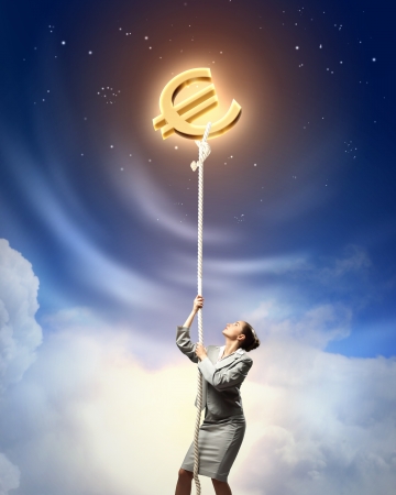 Image of businesswoman climbing the rope attached to euro signの写真素材