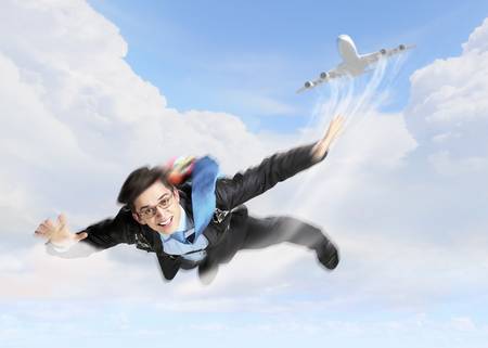Conceptual image of young businessman flying with parachute on backの写真素材