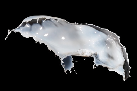White milk splash isolated on black backgroundの写真素材