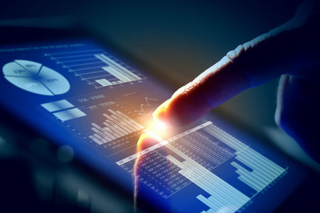 Closeup of finger touching blue toned screen on tablet-pc