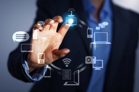Business person pushing symbols on a touch screen interface Business person pushing symbols on a touch screen interface