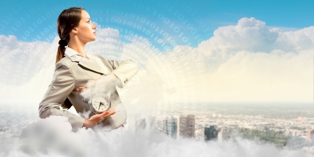 Image of young businesswoman holding alarmclock against illustrationの写真素材
