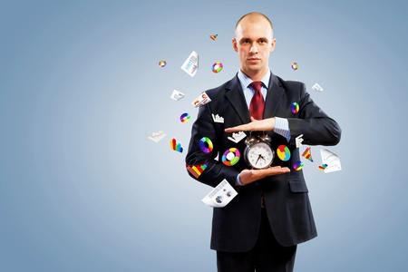 Image of businessman holding alarmclock against illustration background  Collageの写真素材