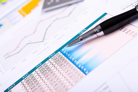 Financial paper charts and graphs on the table