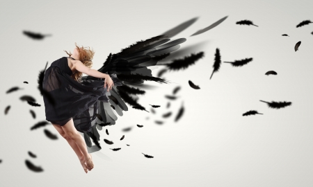 Woman floating in a dance on dark wings  Collage の写真素材