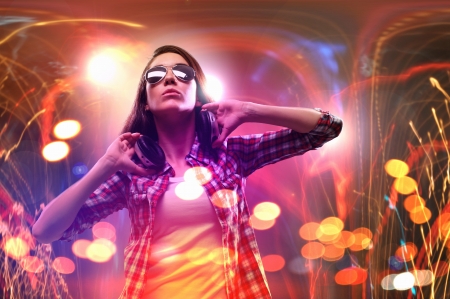 Young girl listens to music  Modulations of color and light の写真素材