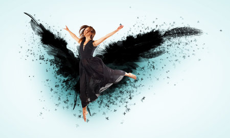Woman floating in a dance on dark wings  Collage の写真素材