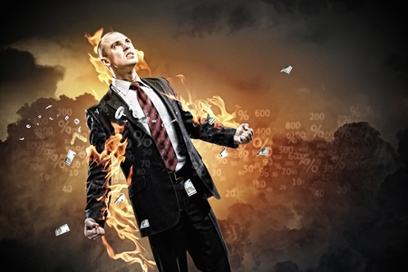 Image of young businessman in anger burning in fireの写真素材