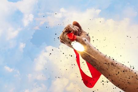 Hand held medal against a stormy skyの写真素材