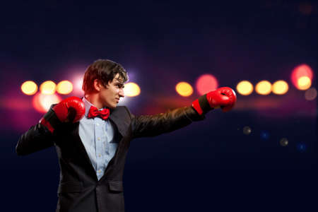 Portrait of a young businessman boxing  conceptual collageの写真素材