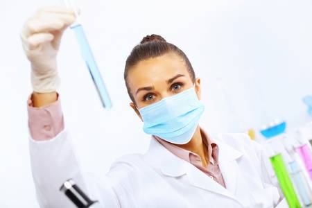 Young female scientist working with liquids in laboratoryの写真素材