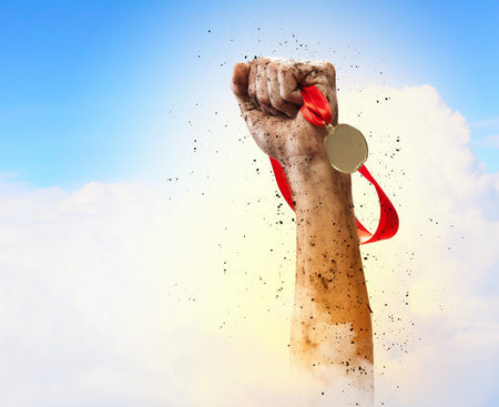 Hand held medal against a stormy skyの写真素材